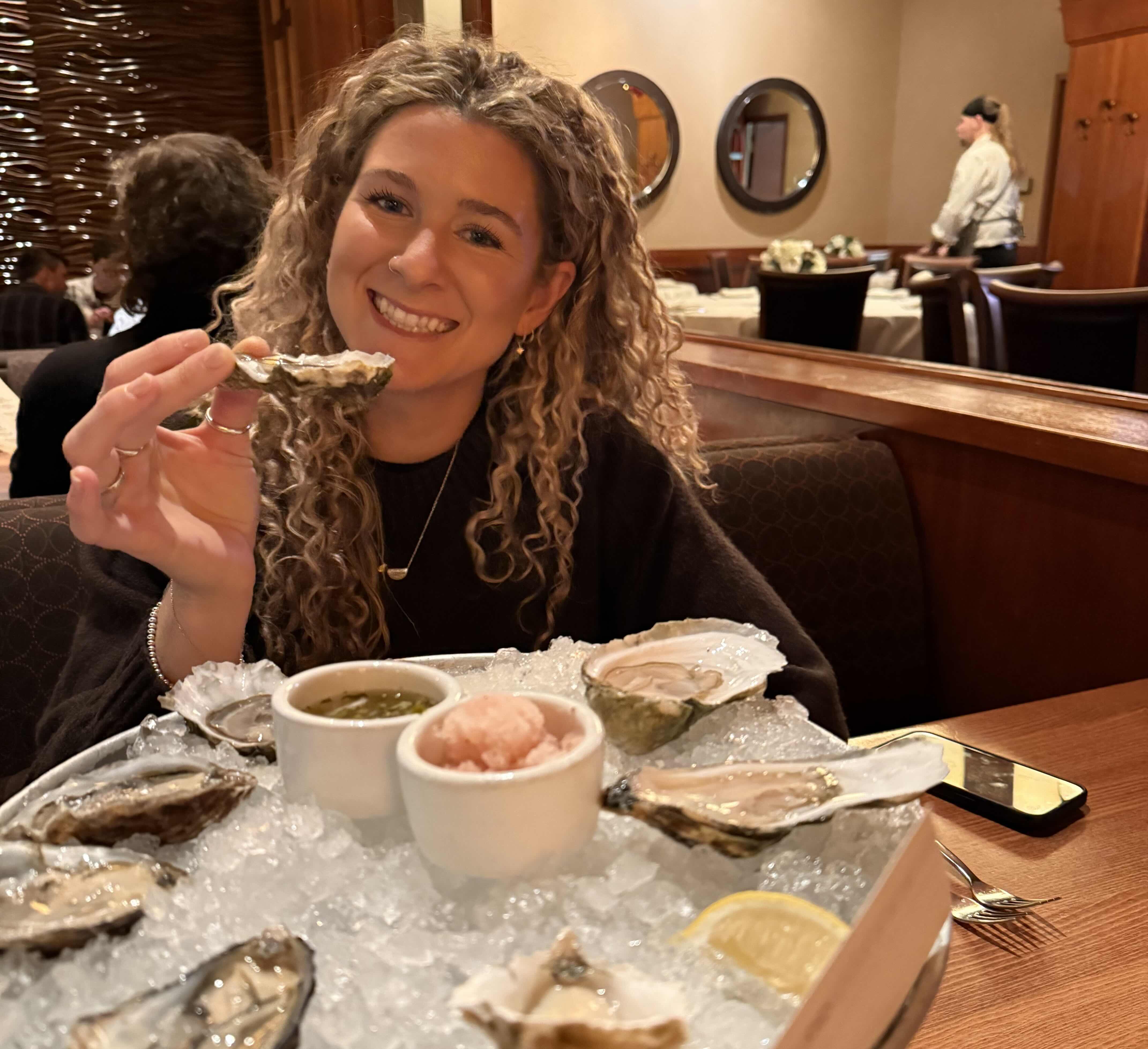 Lucy enjoying oysters at dinner